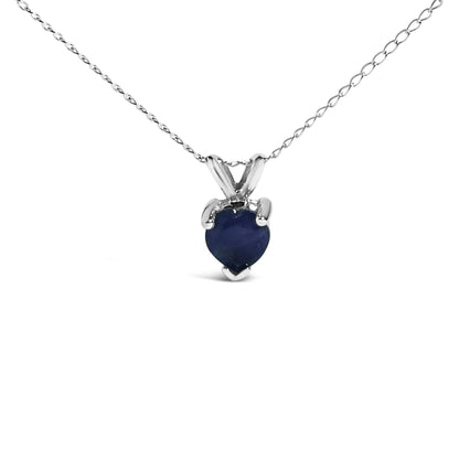 Front view of a white necklace with a heart-shaped blue gemstone pendant in a three-prong setting.