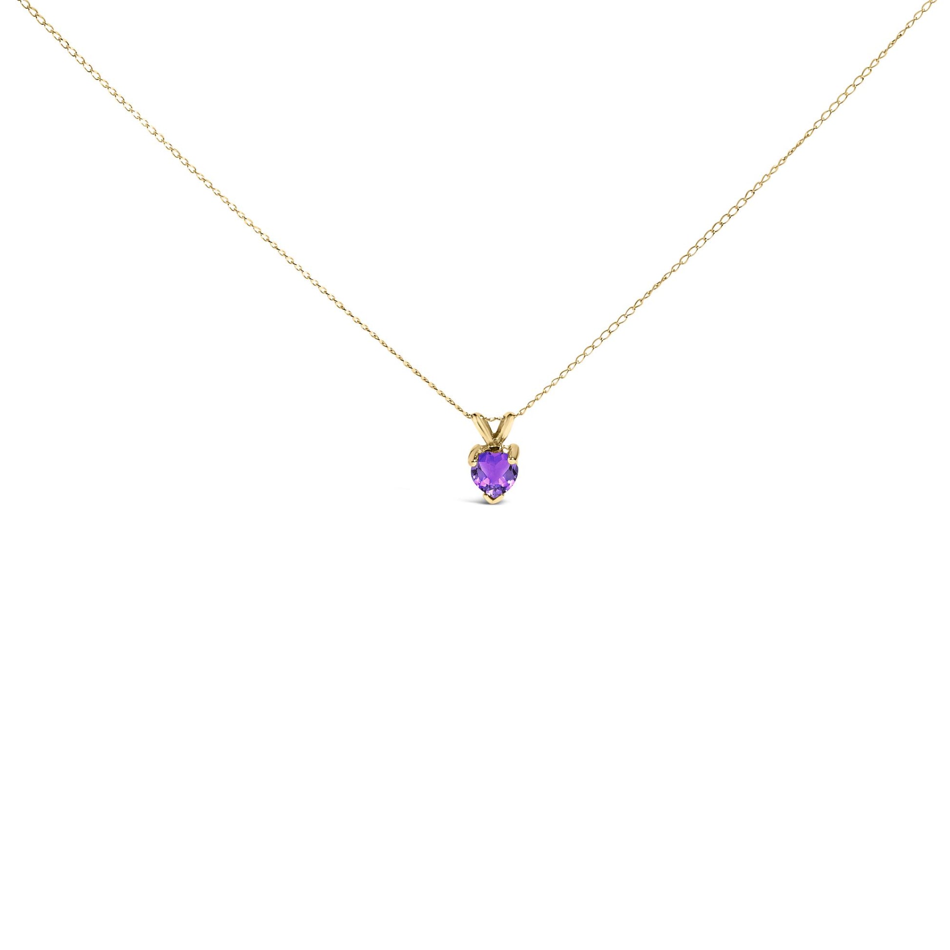 Yellow metal necklace with a heart-shaped purple gemstone pendant in a three-prong setting, shown from the front on a white background.