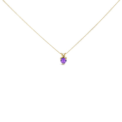 Yellow metal necklace with a heart-shaped purple gemstone pendant in a three-prong setting, shown from the front on a white background.