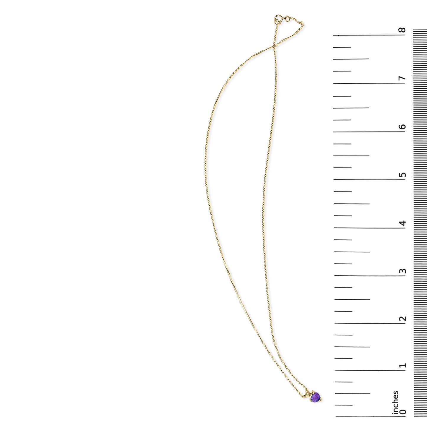 Yellow metal necklace with a heart-shaped purple gemstone pendant in a 3-prong setting, shown flat on a white background next to a ruler for scale.