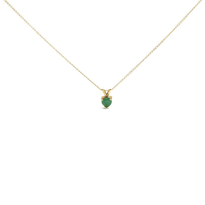 Yellow metal necklace with a heart-shaped green gemstone in a three-prong setting, shown in a front view on a white background.