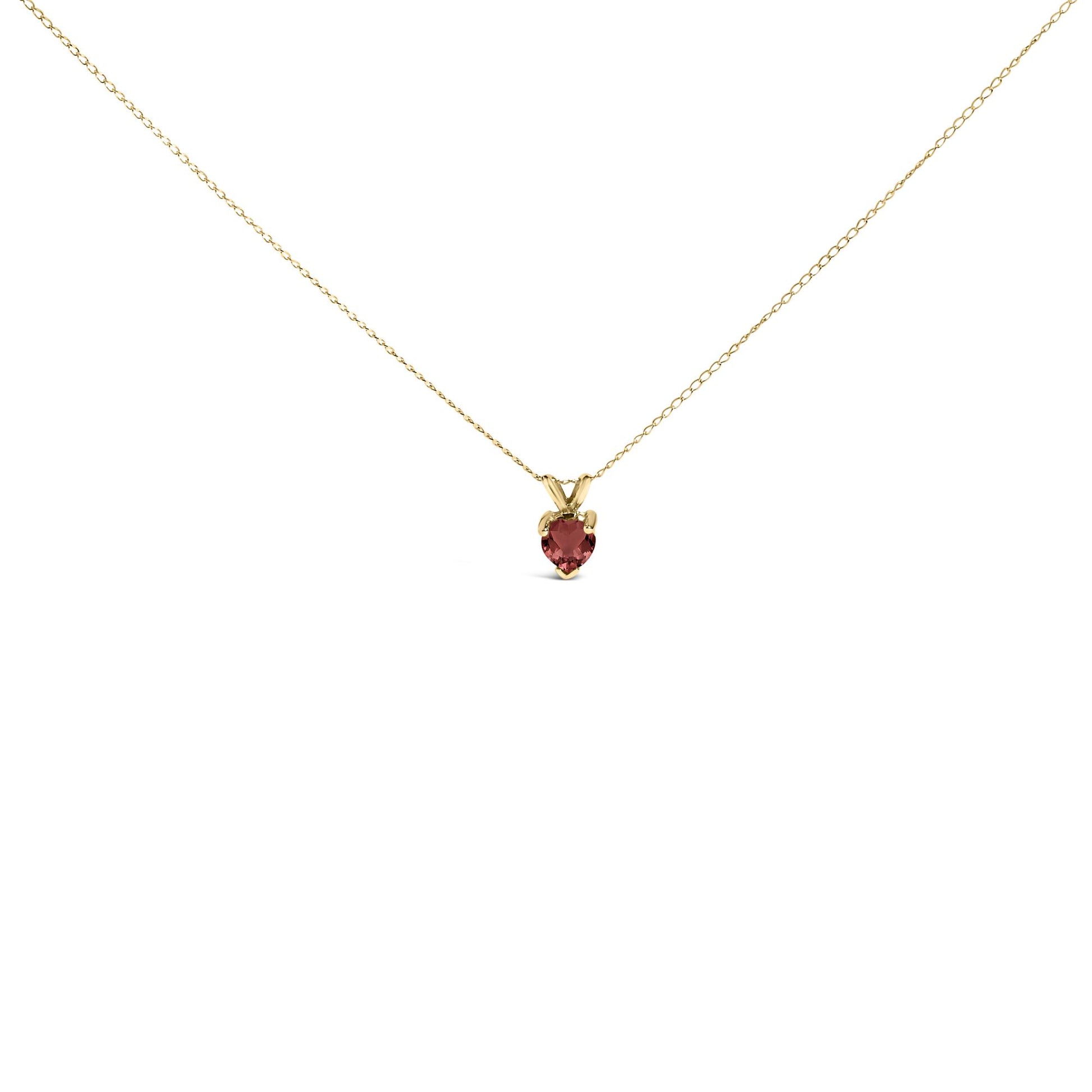 Front view of a delicate yellow necklace with a small heart-shaped red gemstone pendant in a three-prong setting.