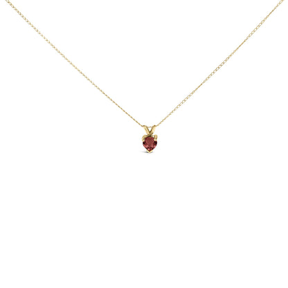 Front view of a delicate yellow necklace with a small heart-shaped red gemstone pendant in a three-prong setting.