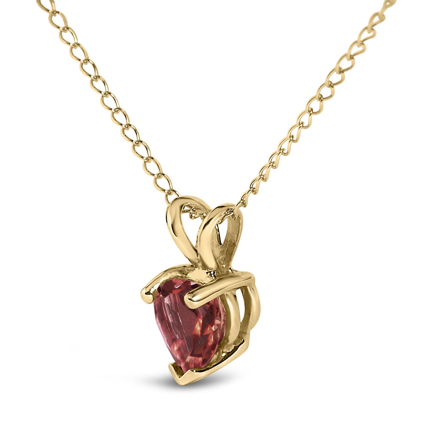 Close-up front angle of a yellow metal necklace with a heart-shaped red gemstone pendant in a three-prong setting.