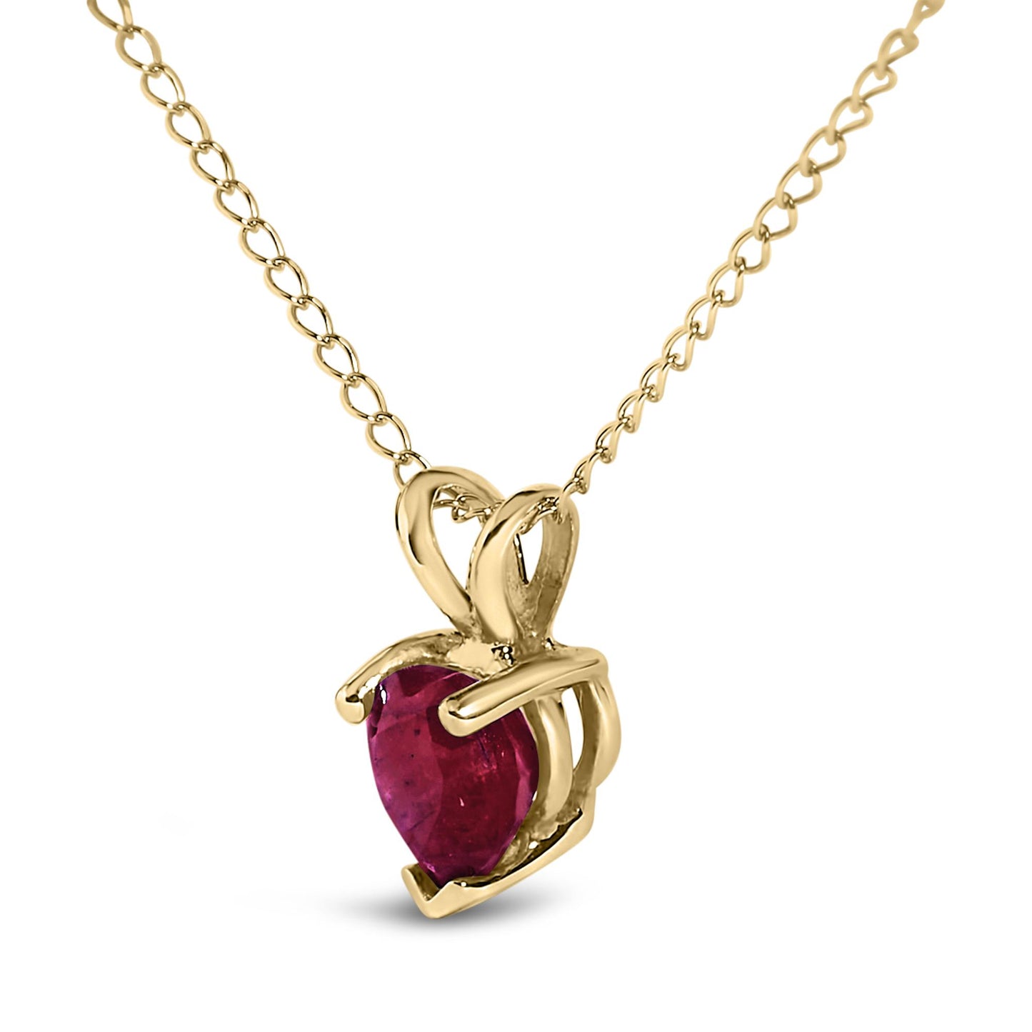 Close-up front angle of a yellow metal necklace with a heart-shaped red gemstone pendant in a three-prong setting.