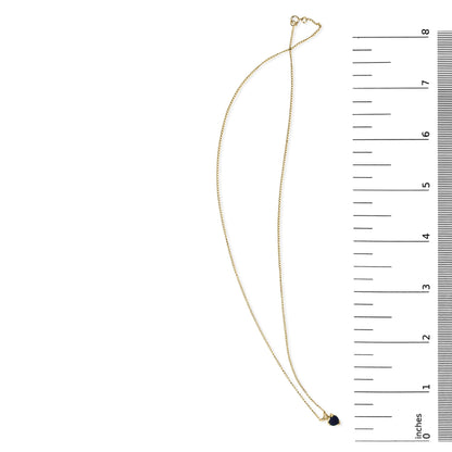 Yellow necklace with a heart-shaped blue gemstone pendant in a 3-prong setting, shown on a scale, top-down view.