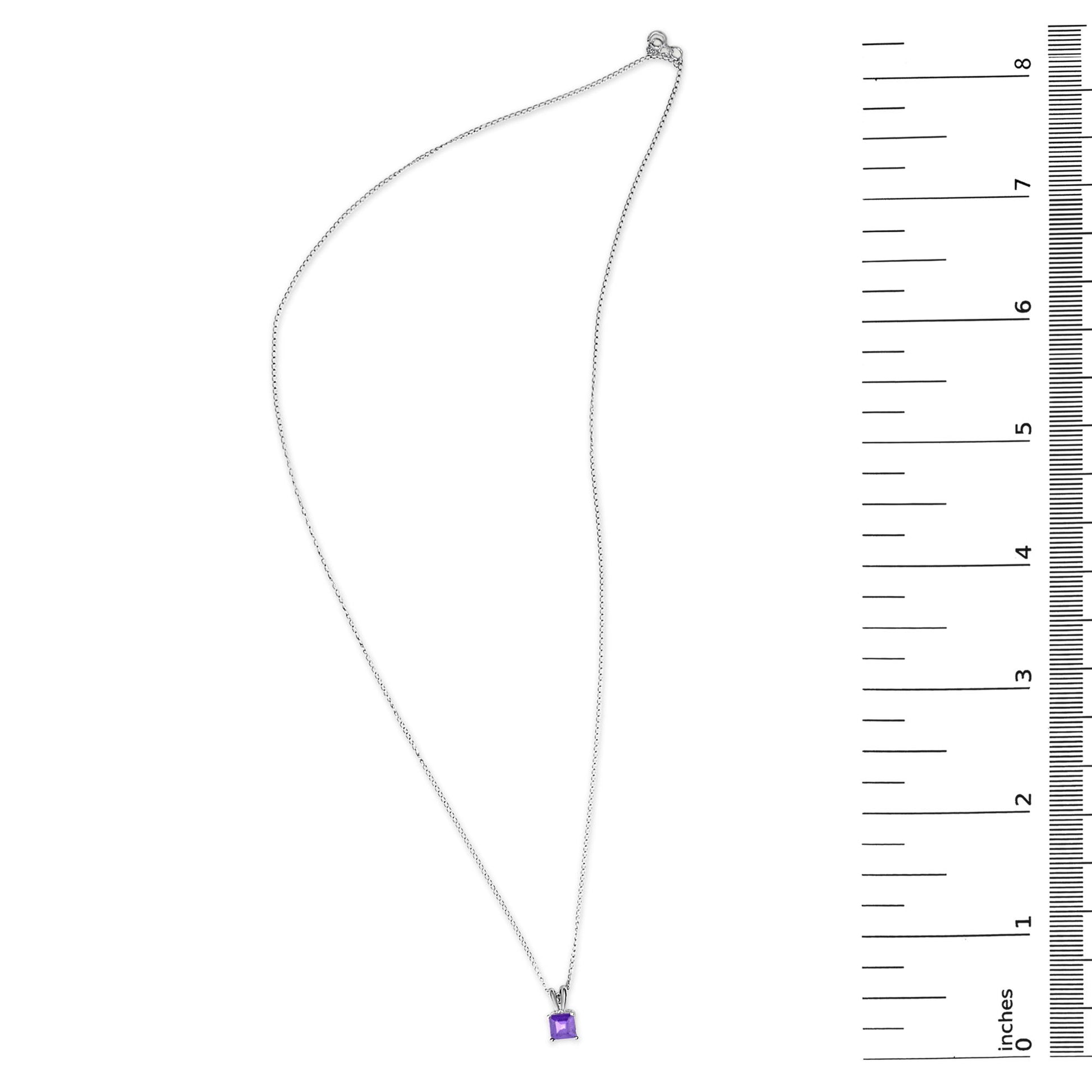 White necklace with a square purple gemstone pendant in a four-prong setting, shown flat on a surface with a measurement scale beside it.