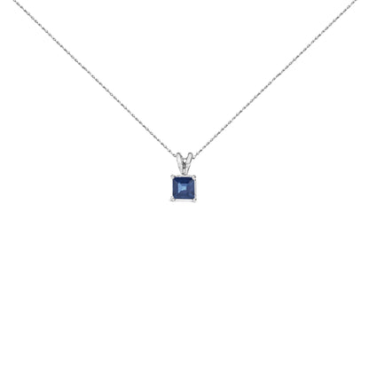 Front view of a white necklace with a single square-shaped blue gemstone pendant in a four-prong setting.