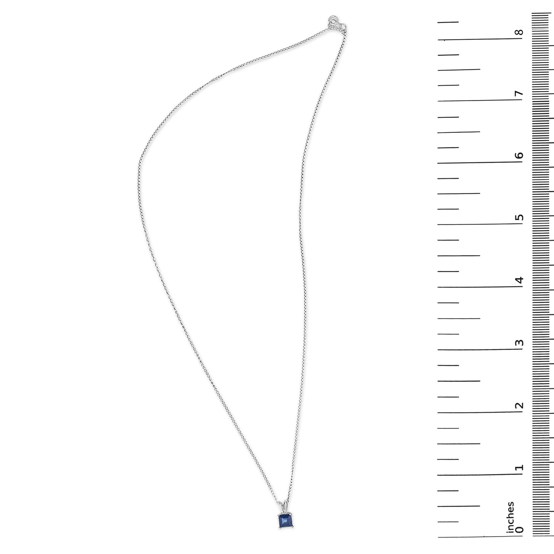 White necklace with a blue square-shaped gemstone pendant in a four-prong setting, shown flat with a measurement scale on the side, top-down angle.