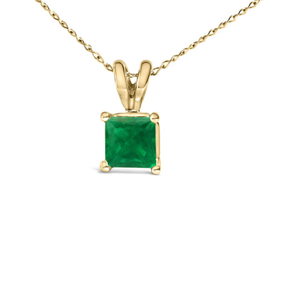Front view of a yellow metal necklace with a princess-shaped green gemstone pendant in a four-prong setting.
