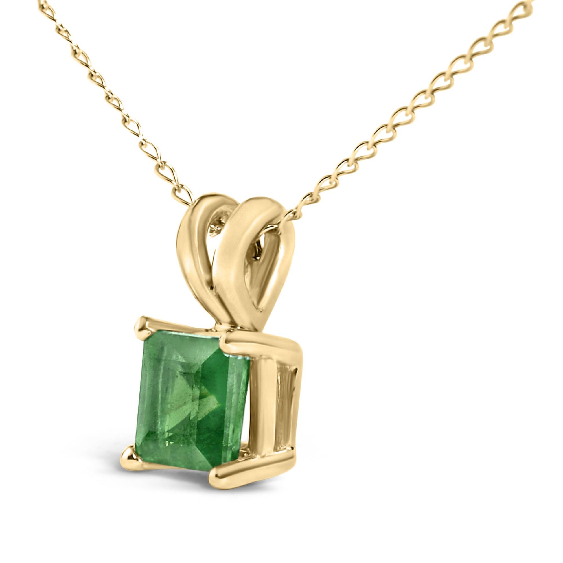 Close-up front angle view of a yellow necklace featuring a princess-shaped green gemstone set in a four-prong setting.