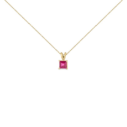 Yellow necklace with a square red gemstone pendant in a four-prong setting, shown in a front-facing close-up shot on a white background.