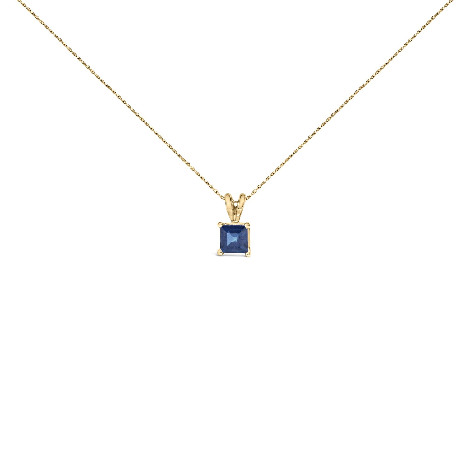 Front view of yellow metal necklace with a single blue princess-shaped gemstone pendant in a four-prong setting.