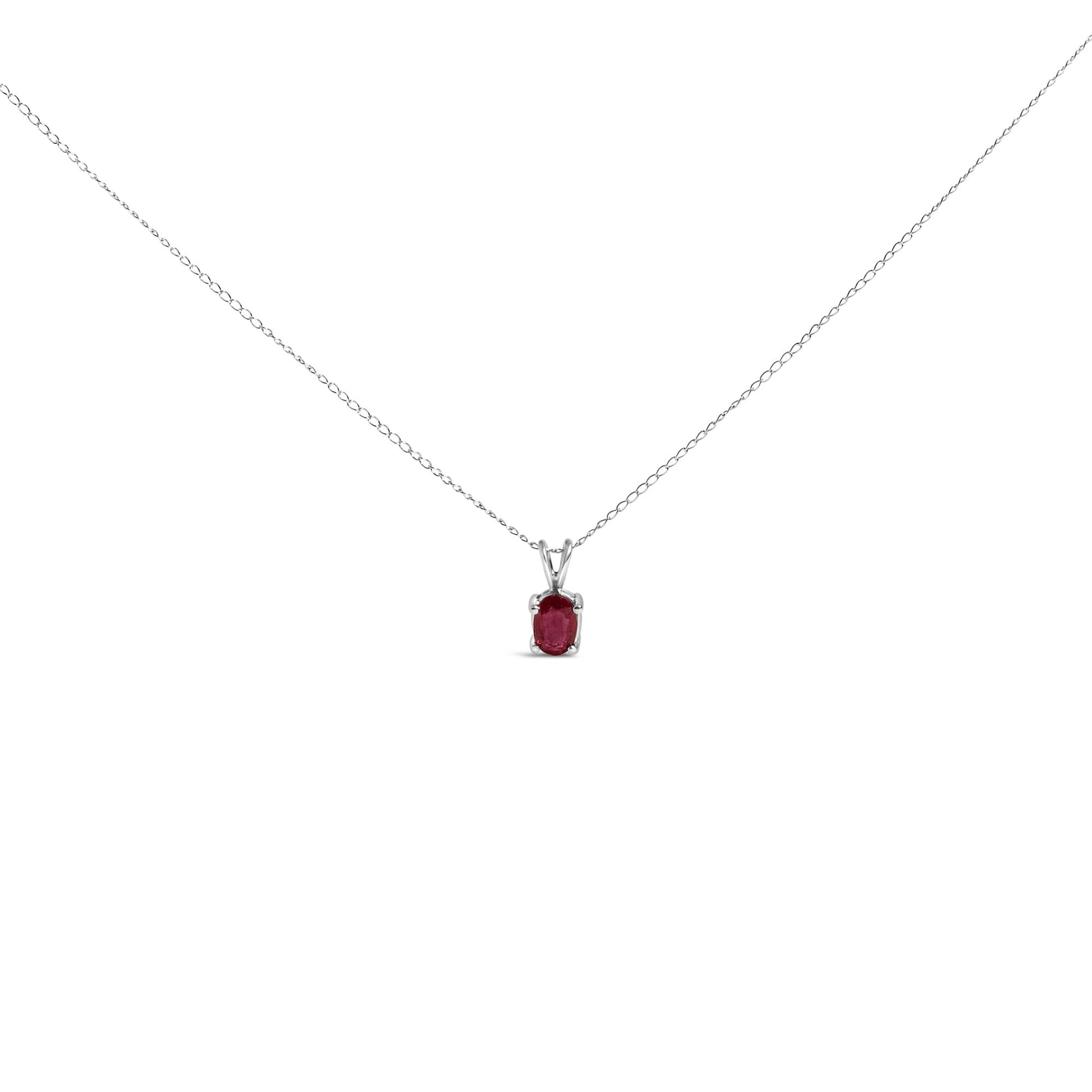Front view of a white necklace with an oval red gemstone pendant in a 4-prong setting.