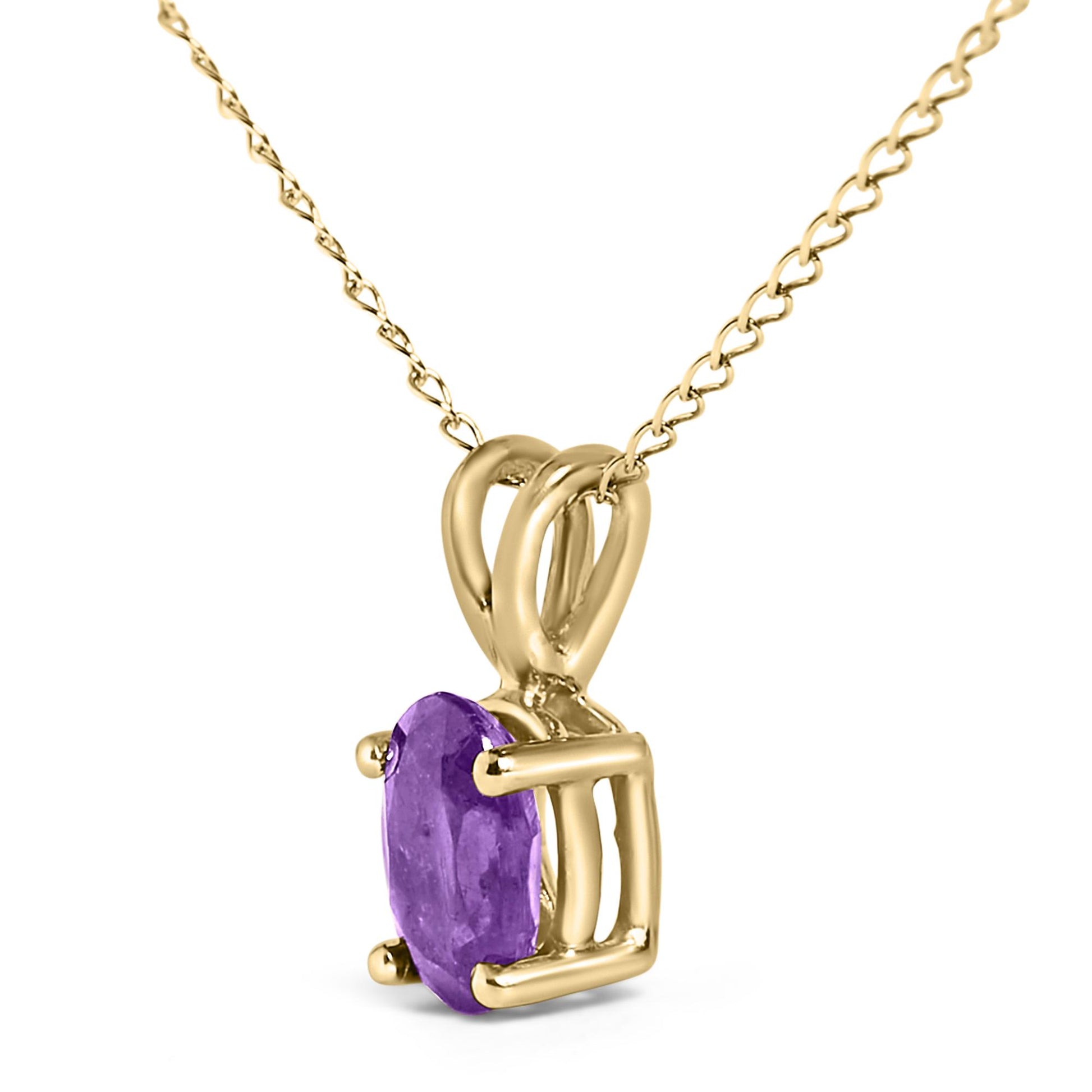 Close-up angled shot of a yellow metal necklace featuring a pendant with an oval purple gemstone in a four-prong setting.