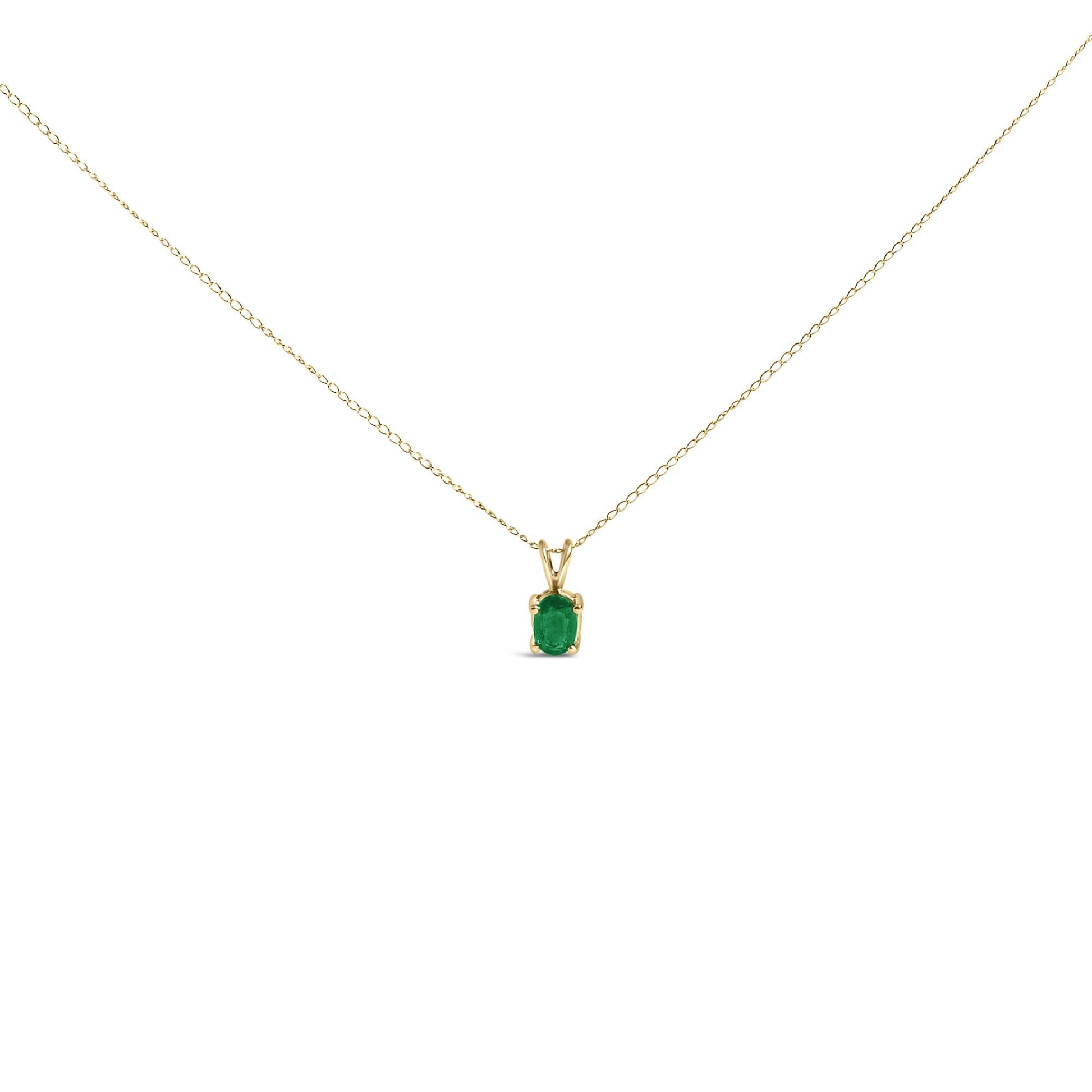 Front view of a yellow metal necklace with a single oval green gemstone pendant in a 4-prong setting.