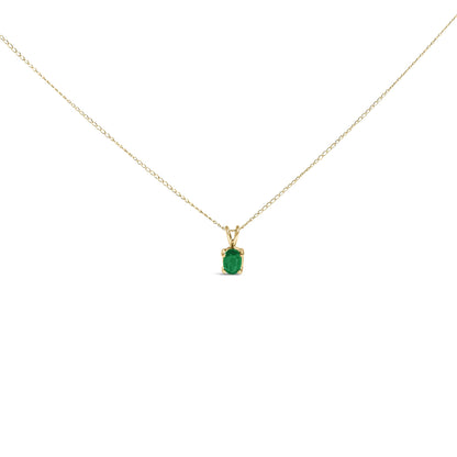 Front view of a yellow metal necklace with a single oval green gemstone pendant in a 4-prong setting.