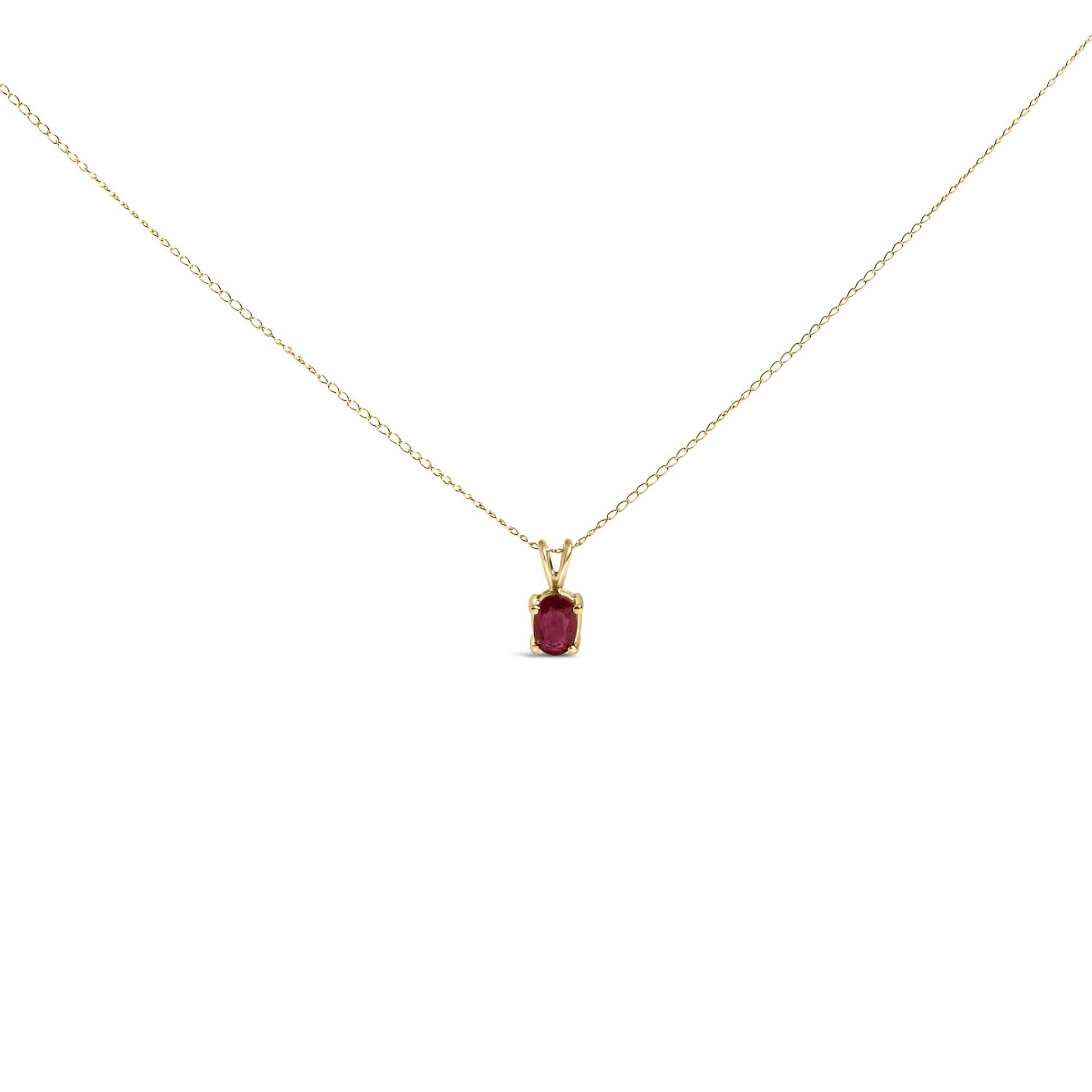 Front view of yellow metal necklace with oval red gemstone in a four-prong setting.