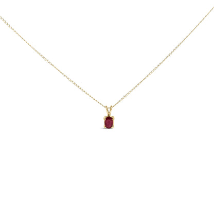 Front view of yellow metal necklace with oval red gemstone in a four-prong setting.
