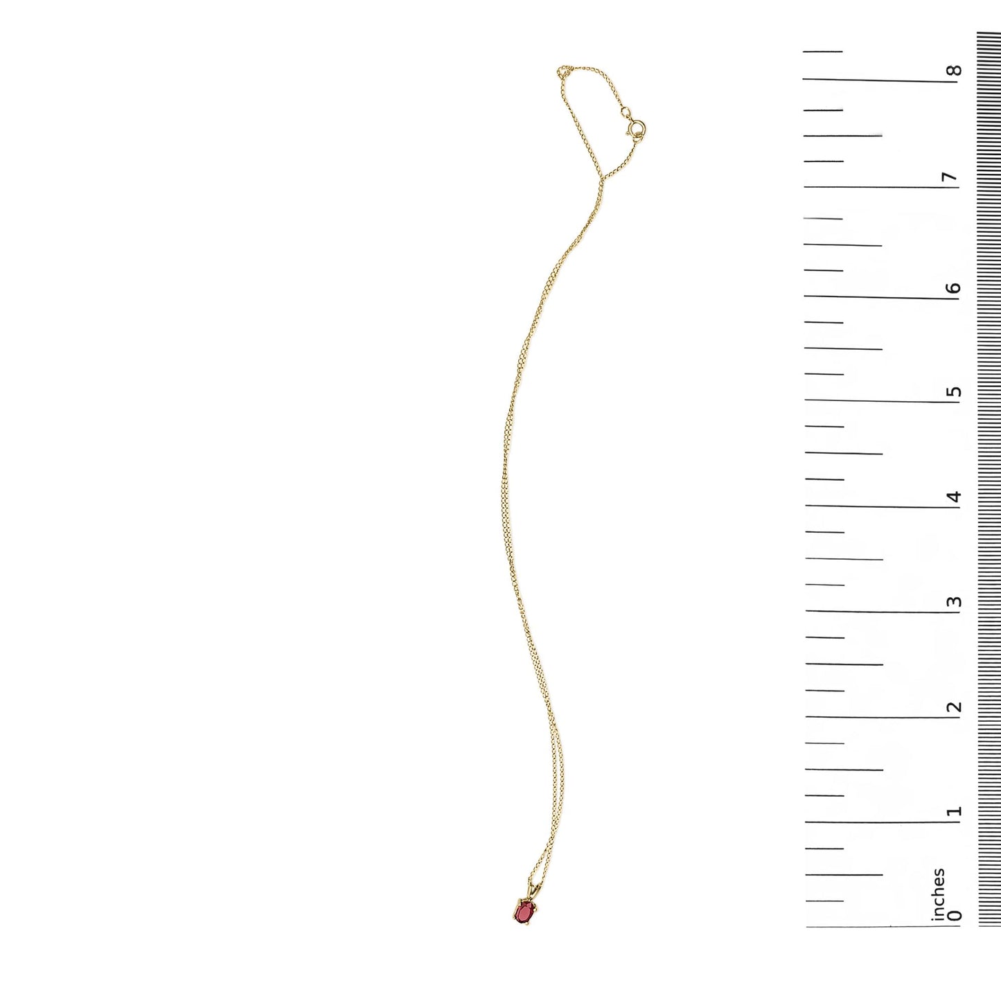 Yellow necklace with a small oval red gemstone pendant in a 4-prong setting, shown flat next to a ruler on a white background, top-down angle.