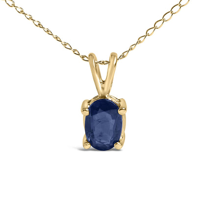 Close-up front view of a yellow metal necklace featuring an oval blue gemstone pendant in a four-prong setting.