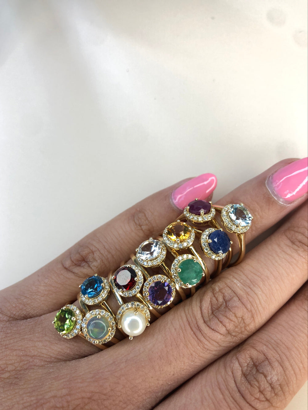Haus of brilliance multiple gemstone rings on hand