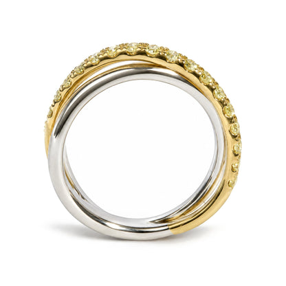 Close-up front angle of two intertwined rings, one yellow metal with prong-set round yellow gemstones encircling it and the other smooth white metal ring.