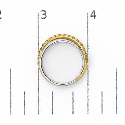 Top-down close-up image of a ring shown on a scale, featuring a two-tone band with yellow and white metal colors, with round yellow gemstones in prong settings all around the yellow metal outer edge.