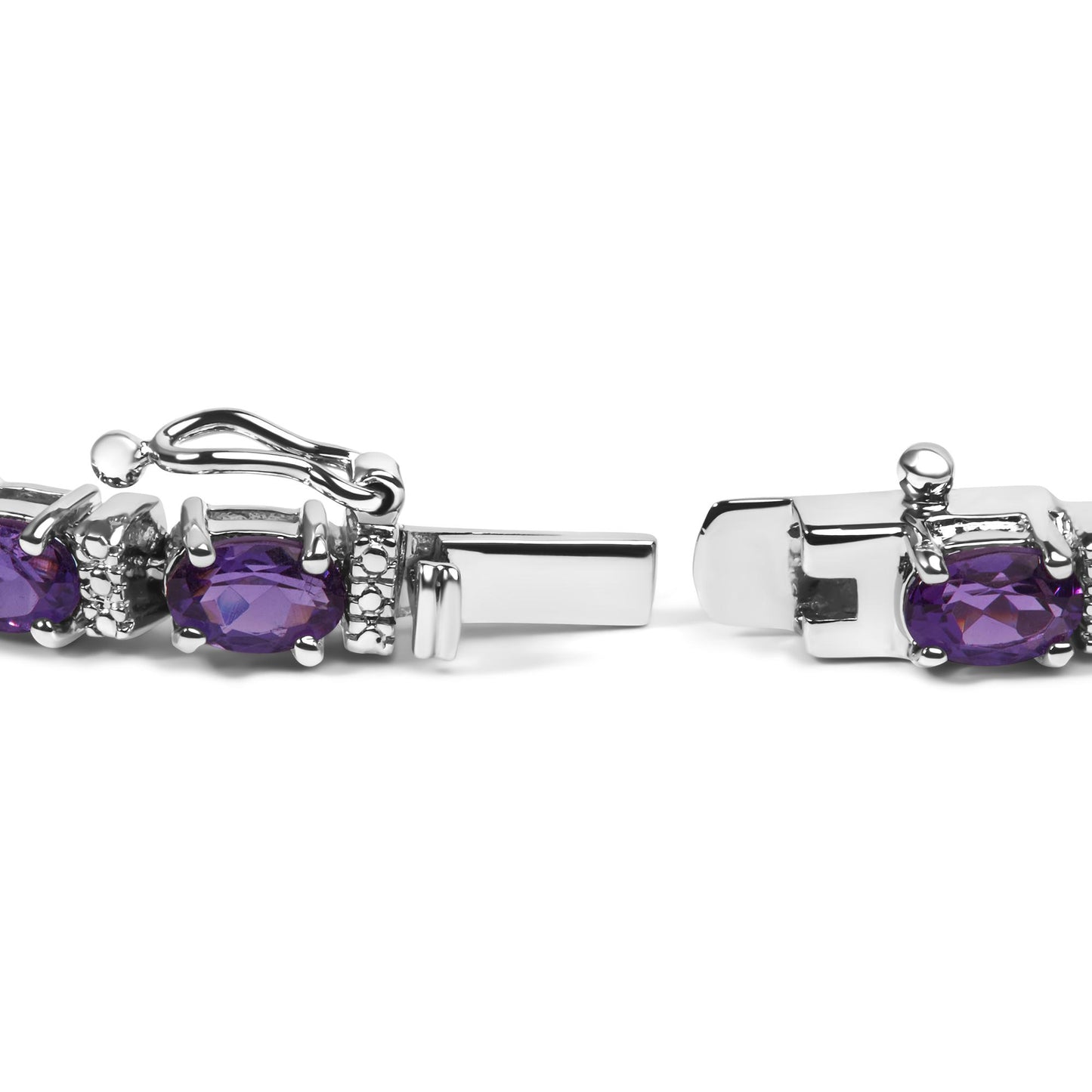 Close-up side view of a white metal bracelet clasp featuring oval purple gemstones and small round white gemstones in a shared prong setting.