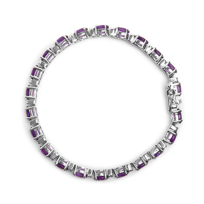 Top-down view of a white metal bracelet featuring oval purple gemstones in four-prong settings alternating with round white gemstones in shared prong settings.