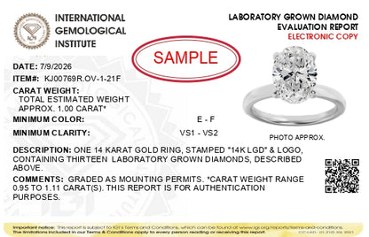 Alt text: White ring shown from a slightly angled top view, featuring an oval-shaped white gemstone held by four prongs in the center, surrounded by multiple smaller round white gemstones in prong settings around the band.