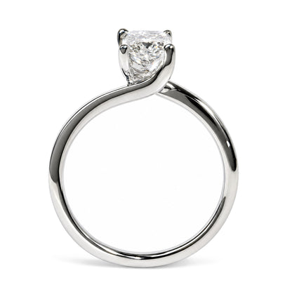 Close-up front angle of a white metal ring with a single radiant-shaped white gemstone in a prong setting.