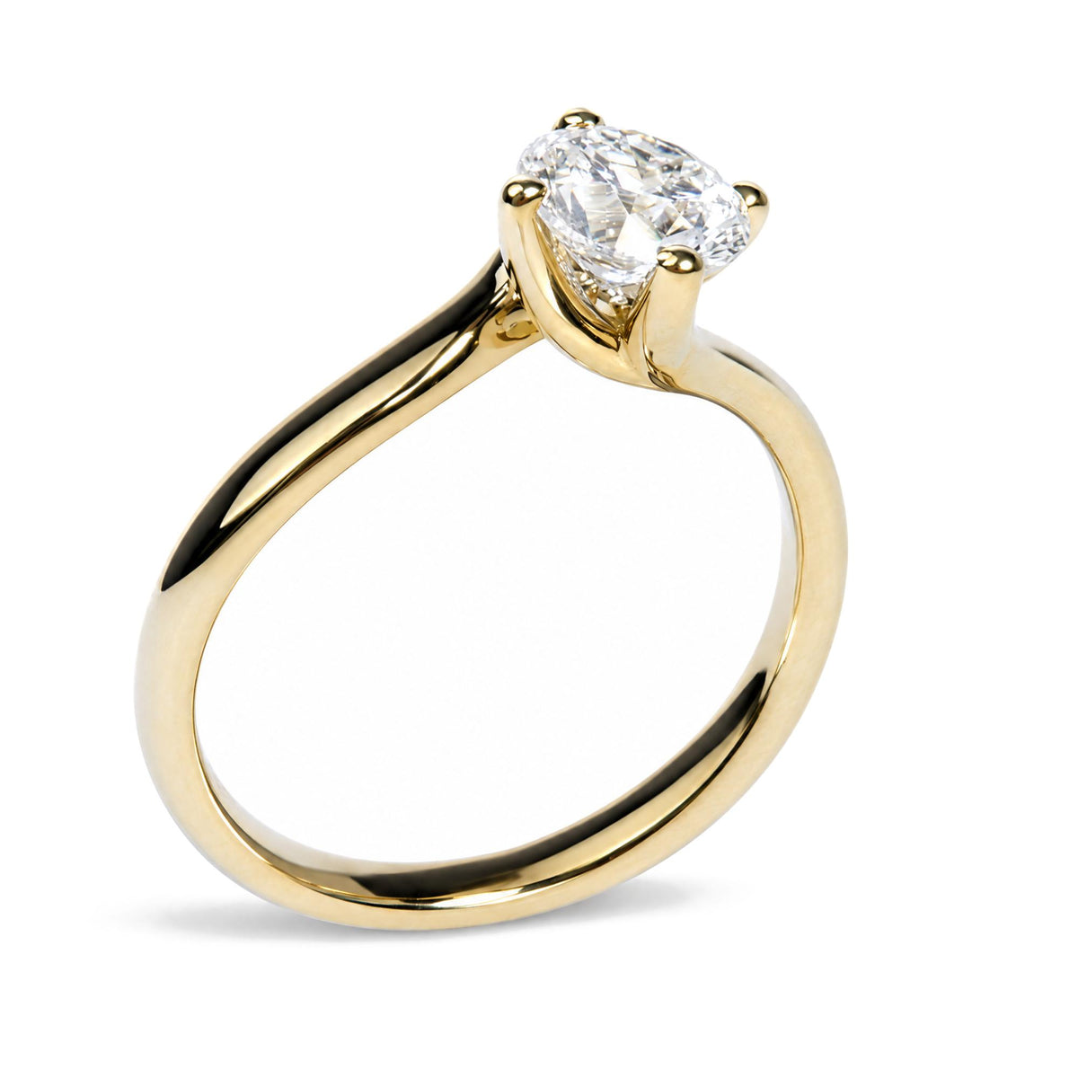 Close-up front angle of a yellow metal ring with a single white round gemstone in prong setting.