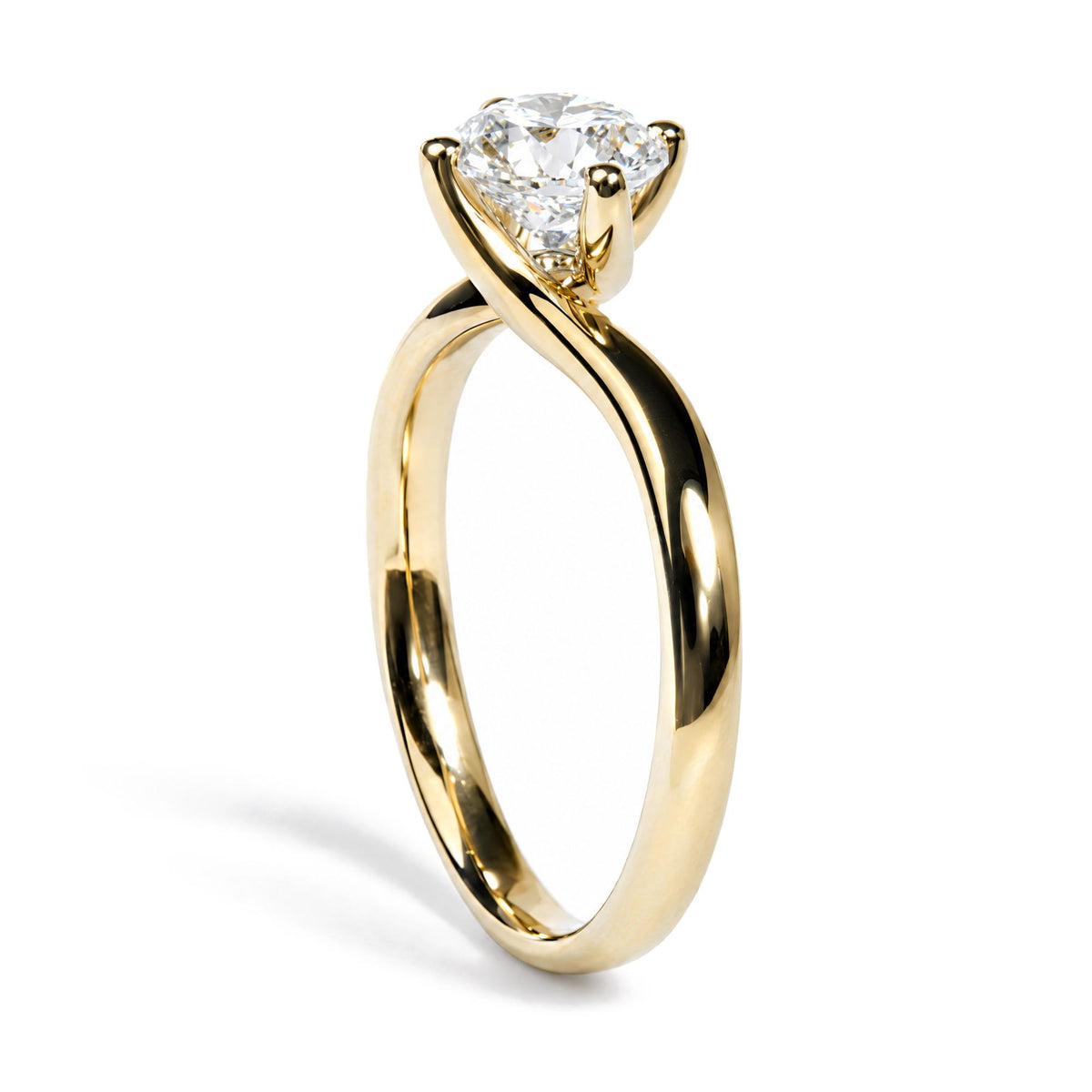 Close-up front angle of a yellow ring with a twisted band design, featuring a single round white gemstone in a prong setting.