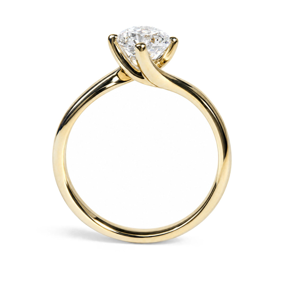 Close-up front angle of a yellow metal ring with a round white gemstone in a prong setting.