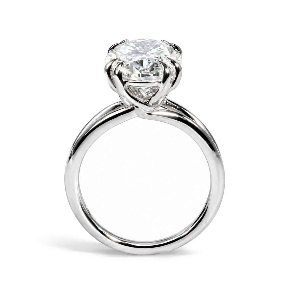 Close-up front view of a white metal ring featuring a single oval-shaped white gemstone in a double claw prong setting.