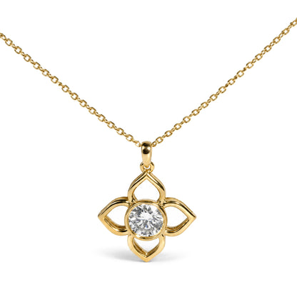 Close-up front view of a yellow metal necklace with a flower-shaped pendant featuring an openwork design and a round white gemstone in a bezel setting at the center.