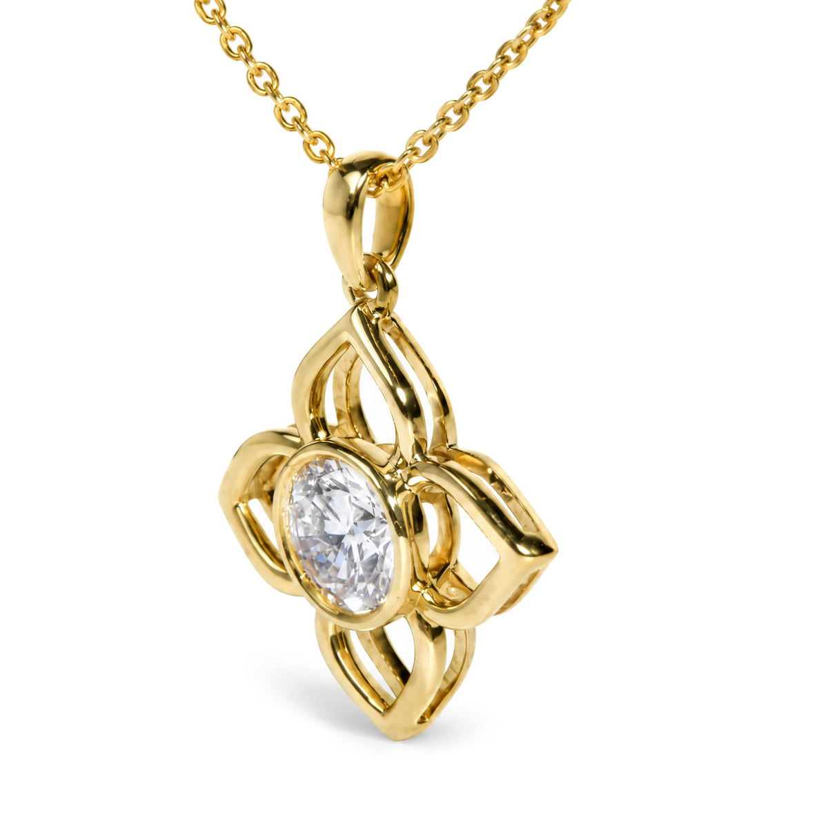 Close-up front angle of a yellow metal necklace with an abstract pendant featuring a single round white gemstone in bezel setting.