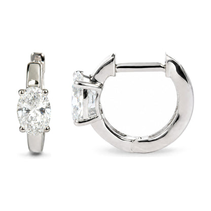 Close-up front and side angle of white metal hoop earrings featuring oval-shaped white gemstones in 4-prong settings.