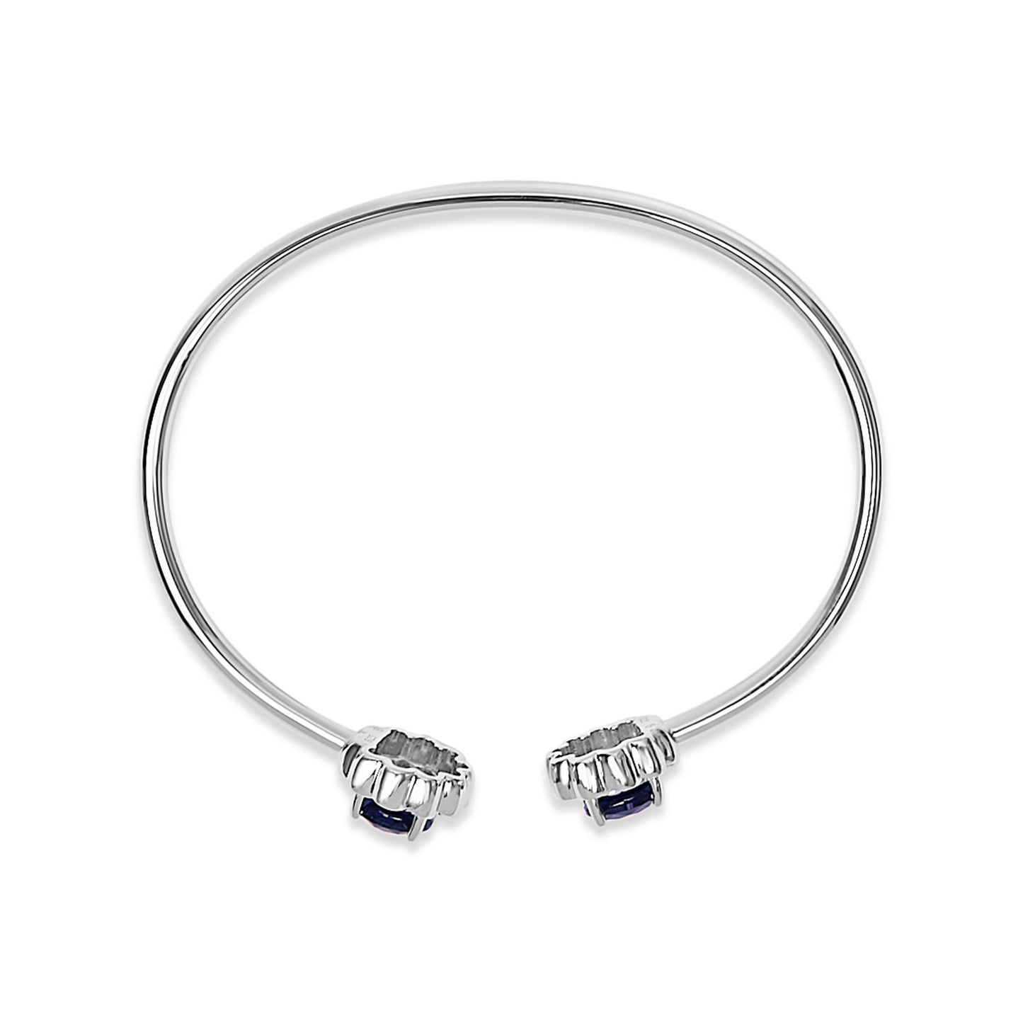 White metal open bangle bracelet with round blue gemstones at each end, shown from a top angle on a white background.