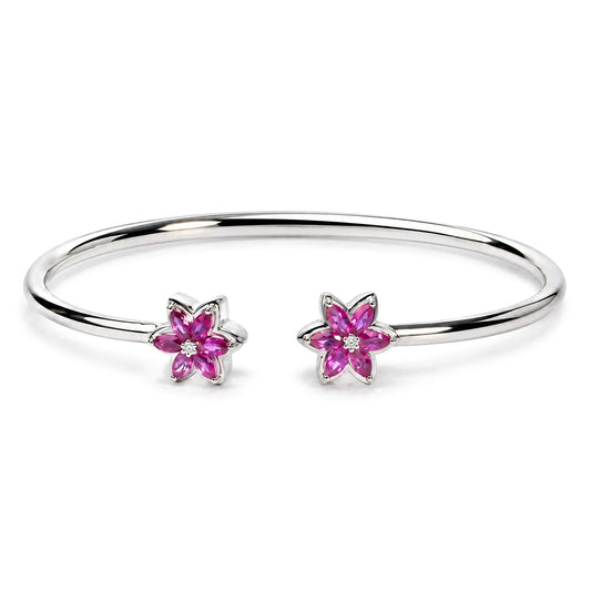 Front view of .925 sterling silver ruby with diamond accent floral flexy open bangle bracelet showcasing two floral ends on a white background