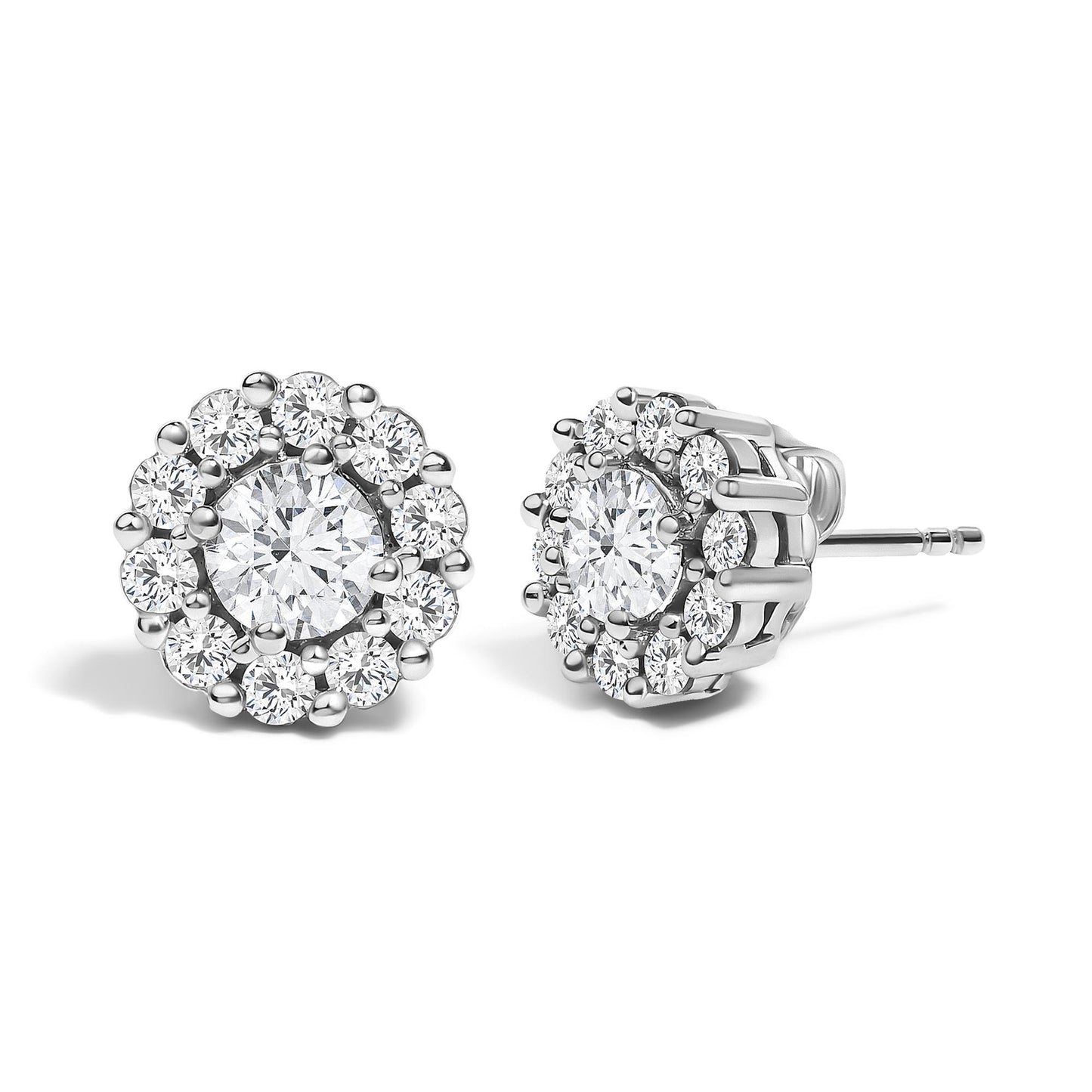 Front and side angled view of white metal stud earrings featuring a central round gemstone in 4-prong setting, surrounded by a cluster of smaller round gemstones in shared prong setting.