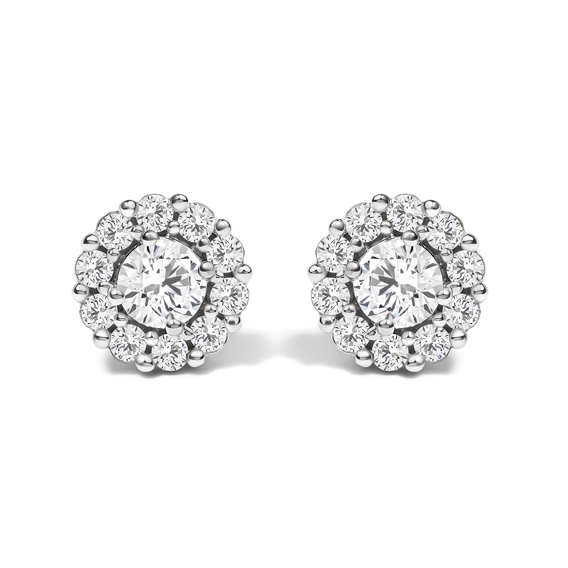 Pair of round white metal stud earrings with a central round white gemstone in four-prong setting, surrounded by smaller round white gemstones in shared prong setting, shown from the front angle on a white background.