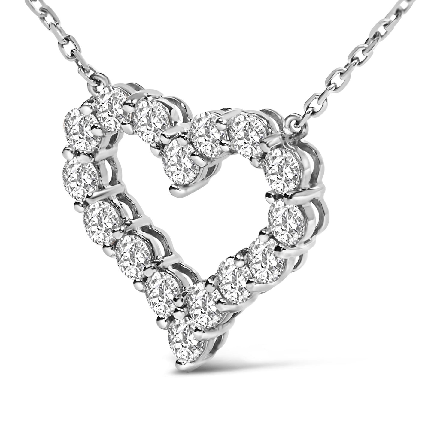Close-up front angle of a white heart-shaped necklace pendant with round white gemstones in a shared prong setting on a white chain.