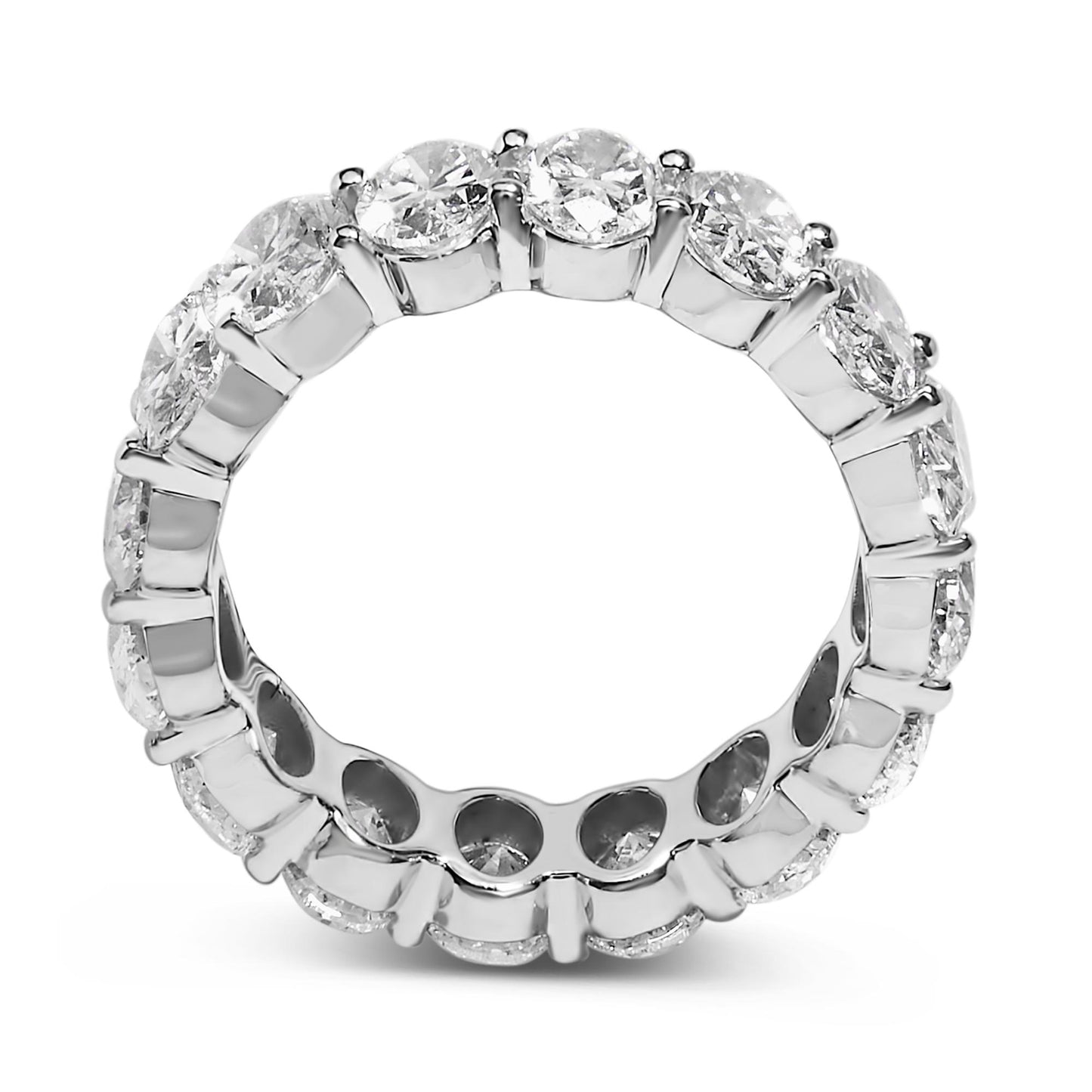 Close-up front angle of a white metal ring featuring a continuous row of white oval-shaped gemstones in a shared prong setting.