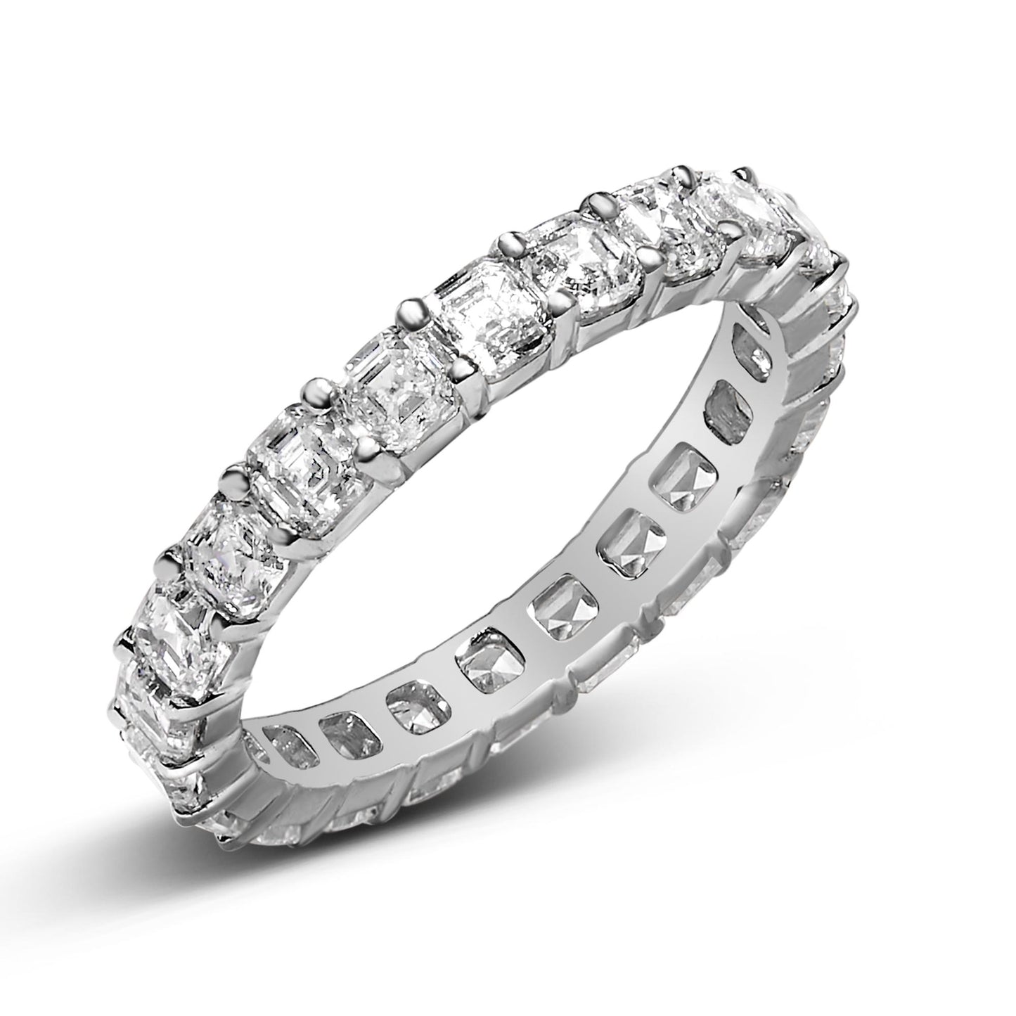 Close-up angled view of a white metal ring featuring a continuous row of asscher-shaped white gemstones in a shared prong setting.