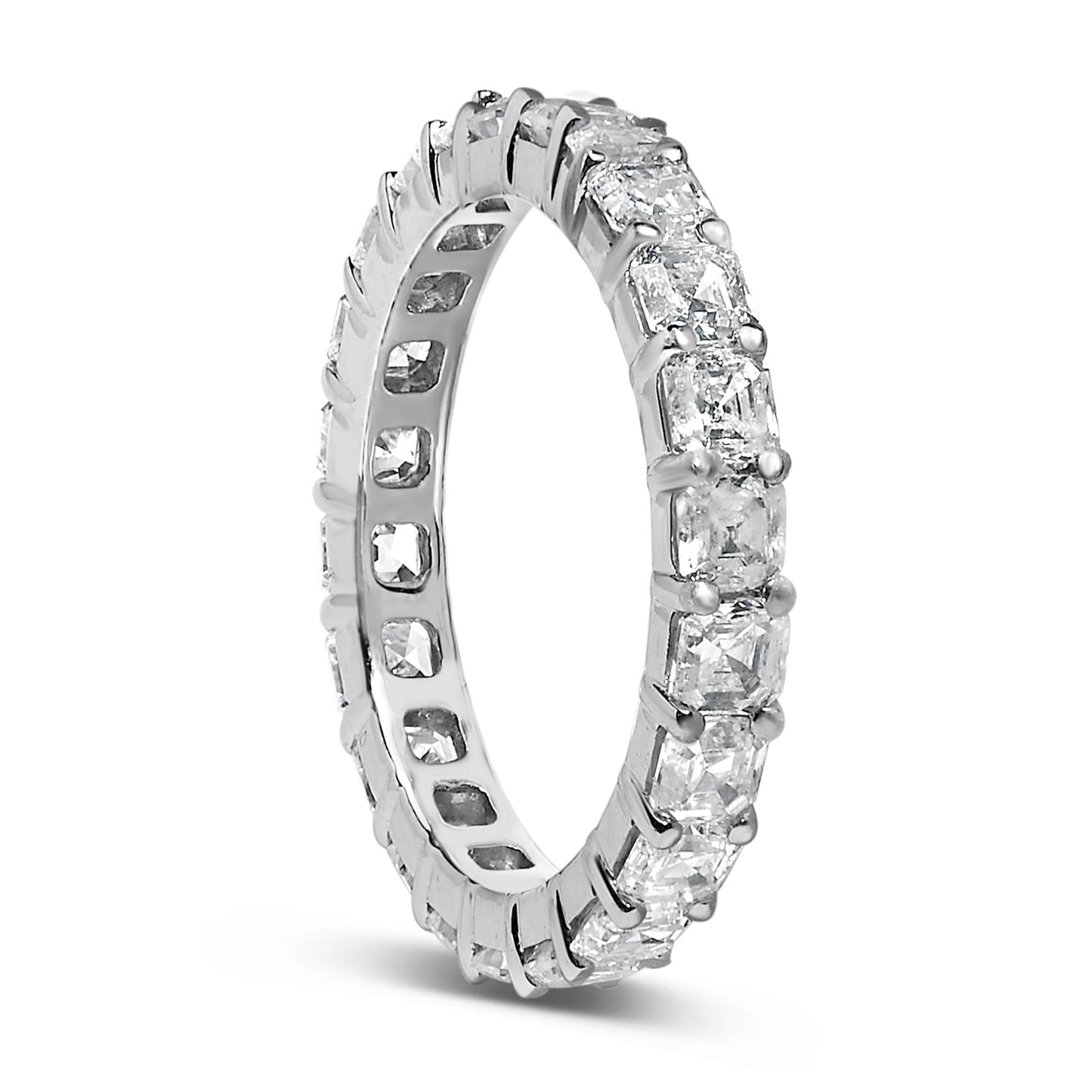 White metal ring with asscher-shaped white gemstones in shared prong setting encircling the band, shown at a slight angle.