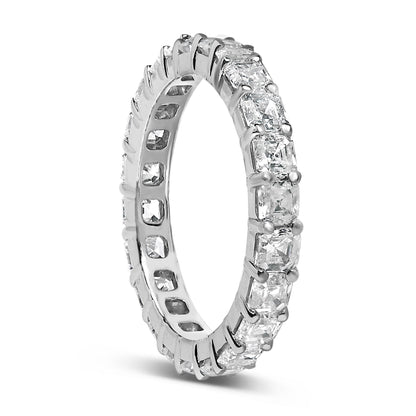 White metal ring with asscher-shaped white gemstones in shared prong setting encircling the band, shown at a slight angle.
