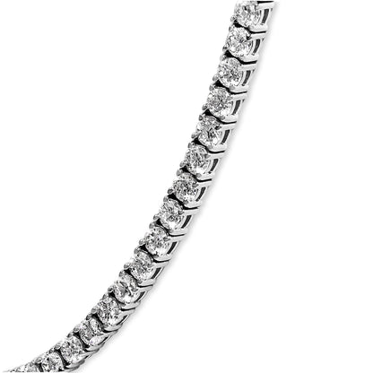 Close-up angled view of a white metal necklace featuring a row of round white gemstones in 4-prong settings.