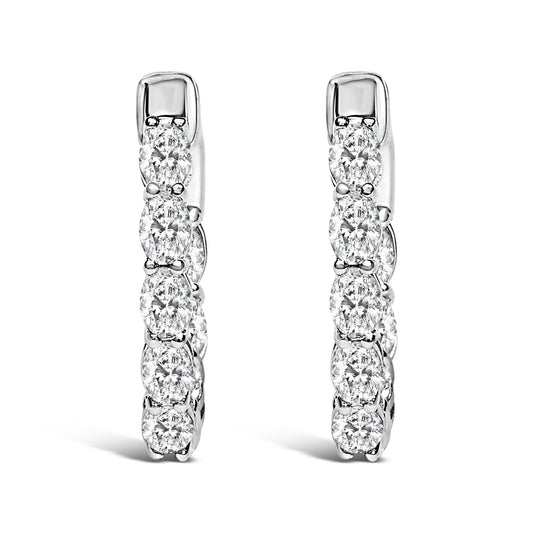 Pair of vertical white metal hoop earrings with oval-shaped white gemstones in a shared prong setting, shown in a front-facing close-up angle on a white background.